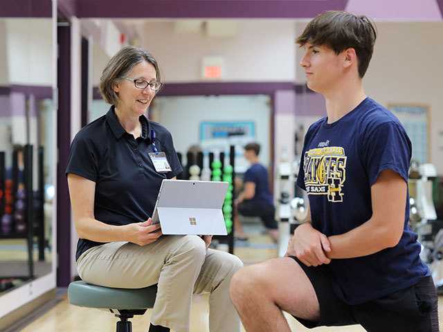 Healthcare provider working with young man.