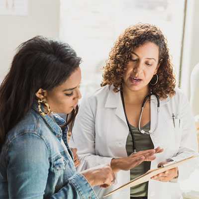 Healthcare provider talking to woman.
