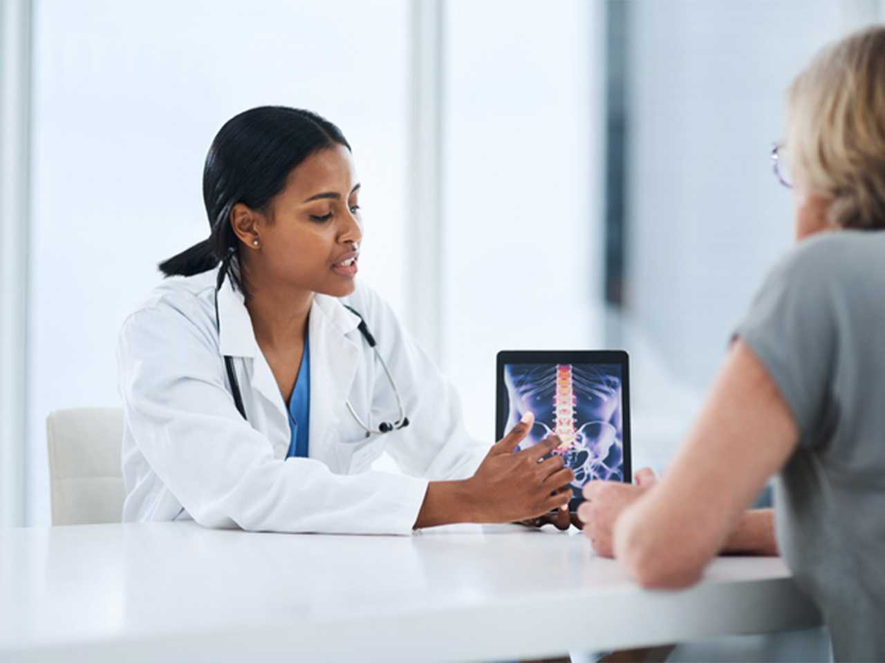 Medical professional at table with woman.