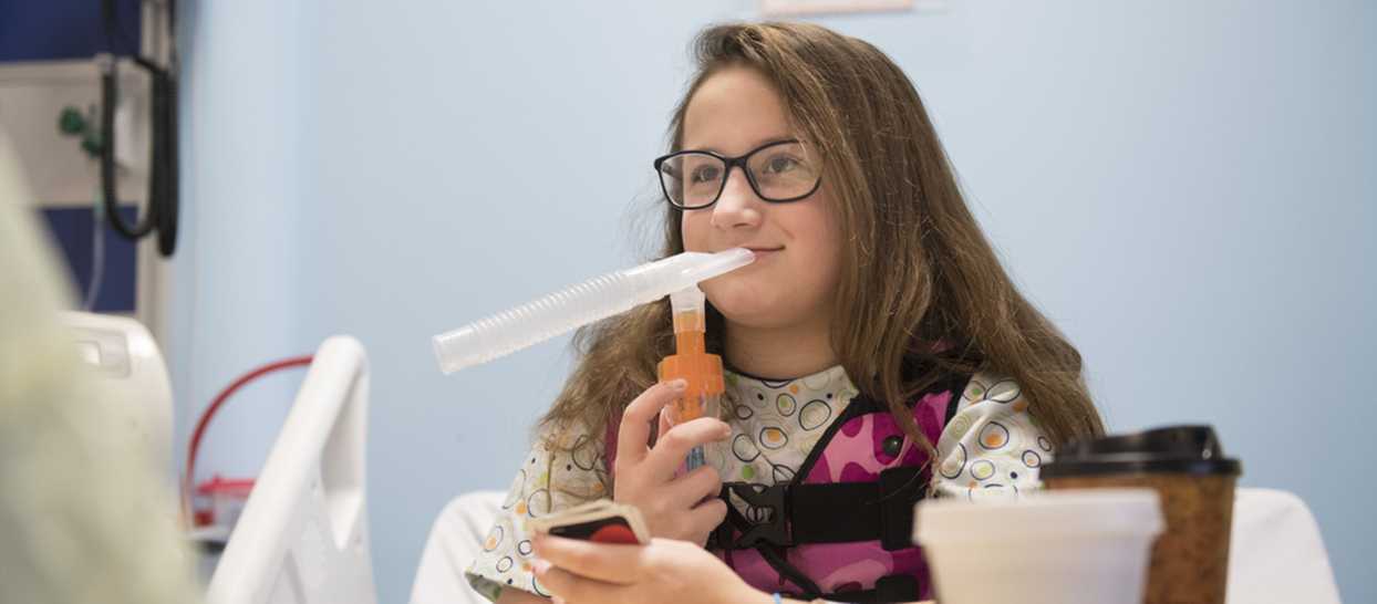 girl using nebulizer