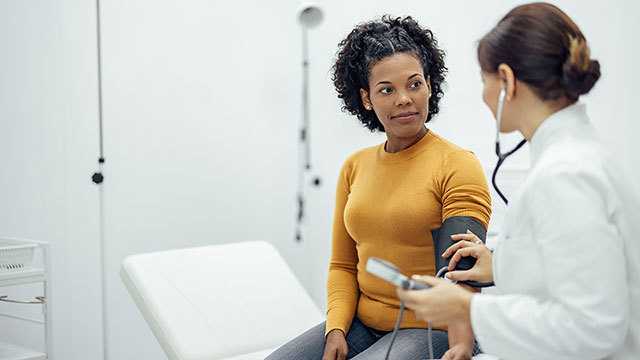 Woman talking to healthcare provider.