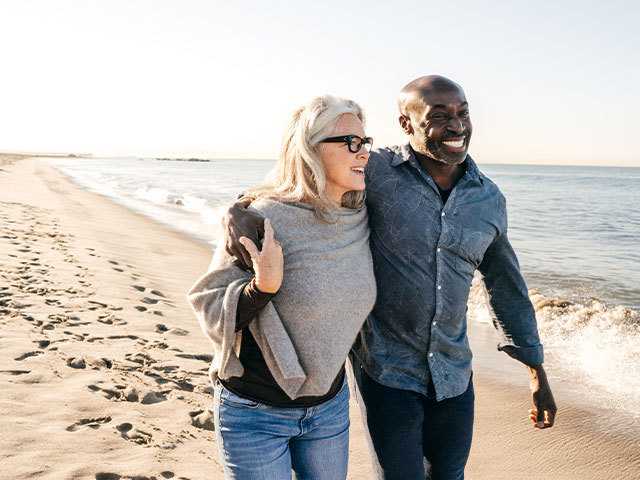 Couple walking on the beach.