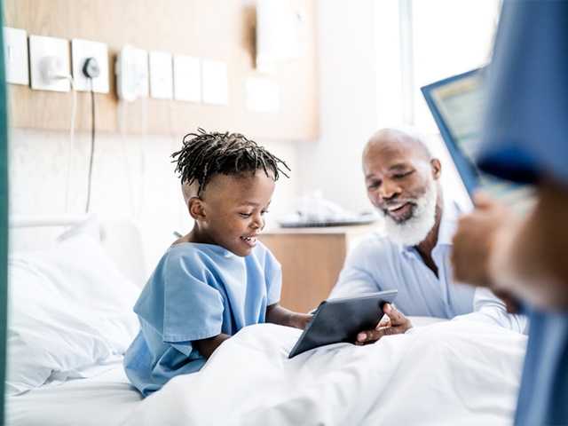 Patient snacking with a smiling nurse nearby